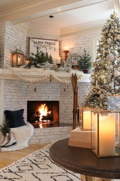 a decorated christmas tree in front of a fireplace