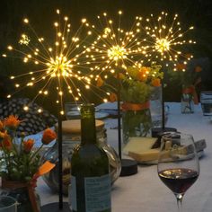 a table topped with bottles of wine and vases filled with flowers