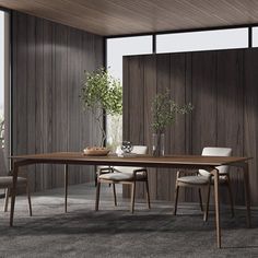 a dining room table and chairs in front of large windows with wood paneling on the walls