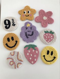 six embroidered patches with smiley faces and flowers