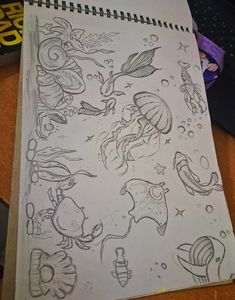 an image of a drawing on paper with fish and sea animals in it's body