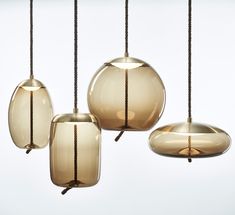 three hanging lights with cords attached to them