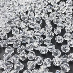 many clear crystal beads on a black surface