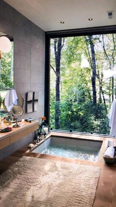 a bathroom with a large window and a jacuzzi tub in the middle of it