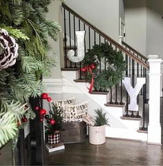 christmas decorations on the banisters and stairs in a home