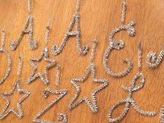 several silver letters and numbers on a wooden surface