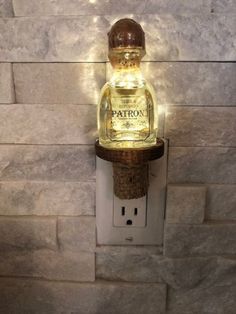 a bottle light is attached to a wall with a cork like holder on the side