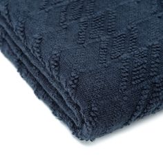 the dark blue towel is folded on top of each other