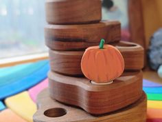 a wooden toy with a pumpkin on top of it