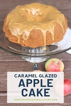 an apple cake with caramel glaze on top and two apples in the background