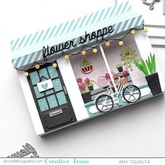 a small shop with a bicycle in front of it and the words flower shop written on the window