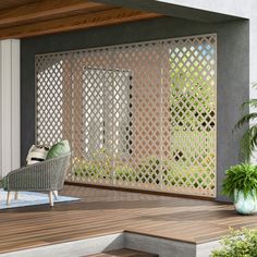 an outdoor area with a chair and potted plants on the deck, next to a pergolated screen