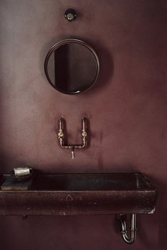 a bathroom sink sitting under a mirror next to a faucet in a room