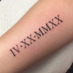 a tattoo with roman numerals on the arm