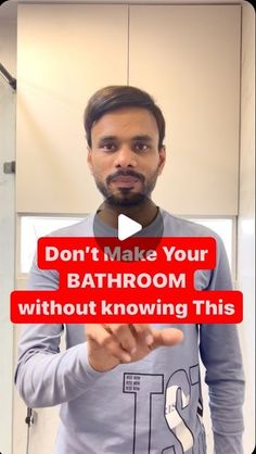 a man holding up a sign that says don't make your bathroom without known this