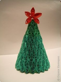 an origami christmas tree with red bow on top