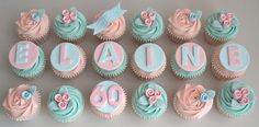 cupcakes with pink and blue frosting are arranged in the shape of letters