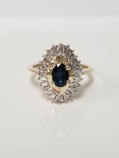 "Thanks for shopping our vintage estate store. We tend to sell well below wholesale and truly hope you enjoy all of our items. Many of the items are one of a kind, so please enjoy scrolling through the pictures and hopefully something will catch your eye. Black spots are from camera or reflections. Estate 10k yellow gold natural oval .50ct sapphire .50ct diamond cocktail style ring. There are 22 baguette diamonds in the setting, and the sapphire is testing natural. Ring size: 6.75 Setting: 3/4\" Vintage Oval Sapphire Ring With Diamond Cut, Vintage Sapphire Ring With Diamond Cut, Oval Shape, Classic Oval Sapphire Ring, Classic Pear-shaped Sapphire Ring, Classic Oval Cluster Ring With Prong Setting, Collectible Oval Sapphire Ring With Diamonds, Classic Marquise Sapphire Ring With Center Stone, Collectible Oval Sapphire Diamond Ring, Oval Sapphire Ring With Diamonds For Collectors