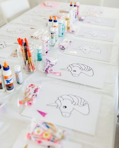 the table is covered with markers, pens and paper art supplies for children to draw