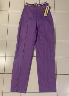 Vintage late 1970's purple pants by Vanderbilt. Rainbow grosgrain ribbon belt. 24" waist, 36" hips, 34" inseam, 12.5" rise.  Unworn deadstock in excellent condition with original tags. Purple Cotton Bottoms With Belt Loops, Fitted Full-length Lavender Pants, Fitted Full Length Lavender Pants, Lavender Fitted Full-length Pants, Retro Fitted Purple Bottoms, Fitted Retro Purple Bottoms, Purple Workwear Pants With Belt Loops, Purple Work Pants With Belt Loops, Fitted Purple Bottoms With Belt Loops