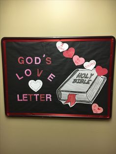 a bulletin board that says god's love letter and an open book with hearts