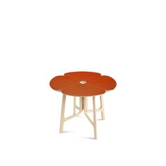 an orange table sitting on top of a white floor