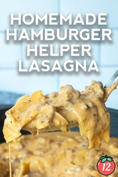 homemade hamburger helper lasagna is being lifted from a skillet with a spoon