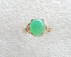 Chrysoprase ring, Chrysoprase set in a floral setting, very cute cabochon ring with AAA Chrysoprase. Chrysoprase cabochon measures 12x10mms AAA quality Chrysoprase weighs 3.5 carats. The 10 carat setting has floral sides and is in yellow gold. Ring size is L 1/5 (Australian size) or 5 7/8 (US size). Ring is ready to ship in 1-2 working days.  We resize free of charge.  Please allow a couple of additional days for resizing. All my rings come in a velvet ring box.  I am highly conscious of environ Luxury Handmade Chrysoprase Ring, Chrysoprase Ring, Velvet Ring Box, Cabochon Ring, Yellow Gold Ring, Ring Box, Rings Statement, Turquoise Ring, Gold Ring