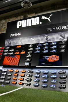 the puma soccer team display is displayed in front of a brick wall and grass area