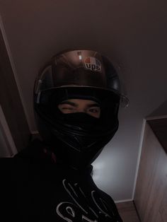 a person wearing a motorcycle helmet and hood