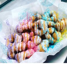 a basket filled with lots of donuts covered in sprinkles