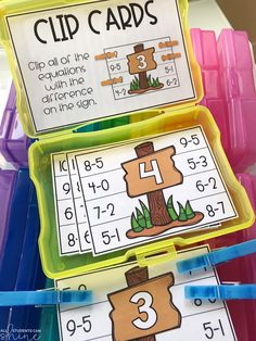 two trays filled with numbers and clip cards to help students learn how to use them