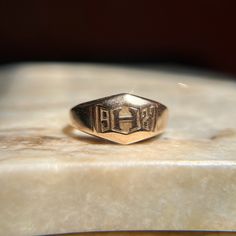 Beautiful vintage 1920's signet that was likely a class ring. This substantial ring features a letter H at the center, surrounded by the year of 1927 - nearly 100 whole years ago! The face shape is a cool geometric/trapezoidal design. Would make an awesome pinky ring if that is the finger it fits :) Wonderful vintage condition. A bit over 4.5 grams, this ring is heavy and well made for its size -- it has such a soothing presence on the finger! There is age appropriate wear and surface scratches Classic Signet Ring For Commemoration, Classic Engraved Signet Ring For Commemoration, Classic Hallmarked Signet Ring For Commemoration, Classic Engraved Ring With Hallmarks, Heirloom Engraved Signet Ring For Commemoration, Classic 14k Stamped Signet Ring For Commemoration, Victorian Initials Signet Ring For Anniversary, Classic Hallmarked Engraved Ring For Commemoration, 14k Gold Heirloom Signet Ring For Commemoration