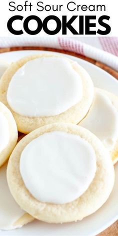 three soft sour cream cookies on a white plate with the words soft sour cream cookies