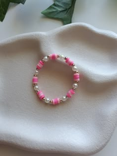 preppy pink colours with pearls, design inspired by AudrinaJewels Pink Preppy Bracelet, Clay Bead Bracelet Ideas Aesthetic Pink, Pink Pearl Bracelet With Colorful Beads, Pink Adjustable Pearl Stretch Bracelet, Adjustable Pink Pearl Stretch Bracelet, Playful Pink Beaded Bracelets As Gift, Pink Pearl Beaded Bracelets With Colorful Beads, Adjustable Playful Pink Jewelry, Trendy Bracelet With Pearl Charm And Round Beads