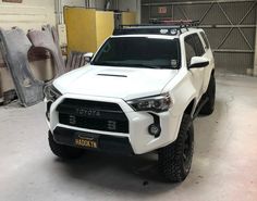 a white toyota truck parked in a garage