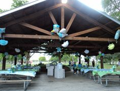 an outdoor covered area with tables and umbrellas