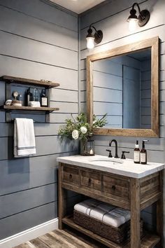 a bathroom with gray walls and wood accents, white towels on the shelf above the sink