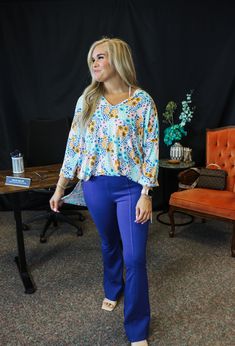 This Mud Pie top is perfect for adding a touch of blue to your wardrobe. With spotted detailing, this tunic top will elevate your look. Made with high-quality materials, this top by Mud Pie is a must-have for any fashion-forward individual. Jersey knit V-neck top features three-quarter length dolman sleeves and hem with side slits. One size fits most. Measures approximately 29" from shoulder to hem. Pie Tops, Blue Floral Top, Mud Pie, Elevate Your Look, Floral Top, Dolman Sleeve, V Neck Tops, Tunic Top, Three Quarter