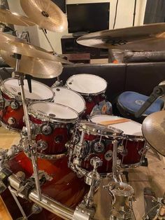 a red drum set sitting on top of a wooden floor