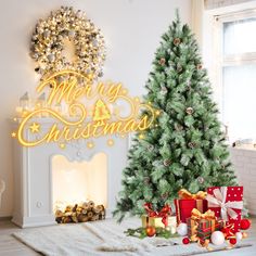 a christmas tree next to a fireplace with presents under it and a merry sign on the wall