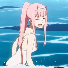 a woman with pink hair is in the water and has her head tilted to the side