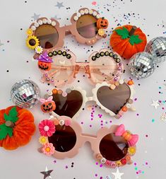 several pairs of sunglasses with pumpkins and flowers on them