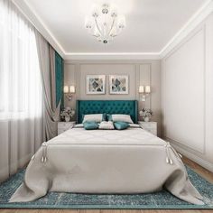 a bedroom with a bed, chandelier and two pictures on the wall above it