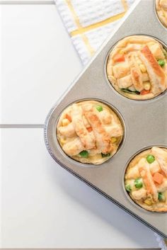 four muffin tins filled with different types of food on a white counter top