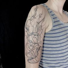 a woman with a flower tattoo on her arm