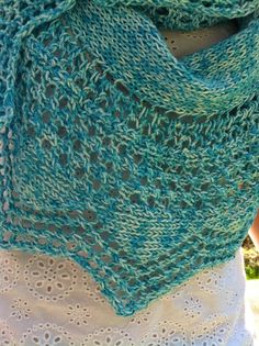 a woman wearing a green knitted shawl