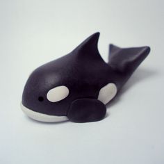 a black and white orca whale toy laying on its side