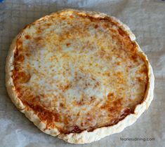 a cheese pizza sitting on top of a piece of wax paper