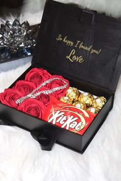 a black box filled with candy and roses